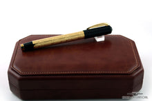 Load image into Gallery viewer, The Fountain Pen with the cap on, closed. Placed on top of the leather presentation box.