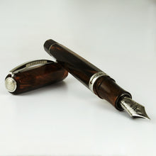 Load image into Gallery viewer, Angled view of the fountain pen leaning on the cap.