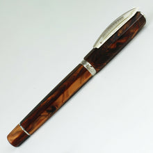 Load image into Gallery viewer, Side view of the Fountain Pen with the cap on, closed. It has a small card underneath the clip with details of the pen's trims.