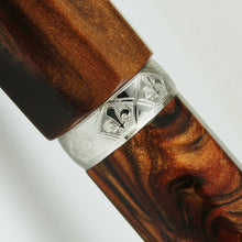 Load image into Gallery viewer, Close up to the cap's ring, featuring an engraving of fleur de lis icons around it.