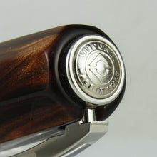 Load image into Gallery viewer, Close up to the cap's top. it has a medal with the logo and "VISCONTI MADE IN ITALY" engraved on it.