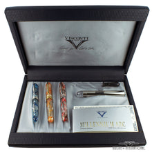 Load image into Gallery viewer, The three fountain pens in their slots of the presentation box, arranged with the documents, booklets, eyedropper, and an accessory.