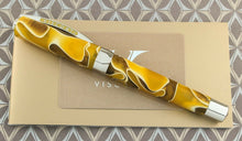 Load image into Gallery viewer, Side view of the fountain pen on top of the certificate and booklets.