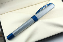 Load image into Gallery viewer, Side view of the Fountain Pen with the cap on, closed. The cap's clip has the word VISCONTI engrave on it.