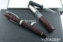 Load image into Gallery viewer, The red fountain pen arranged with the presentation box, portable ink tube, and eye dropper on top of the presentation boxes.