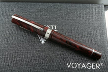 Load image into Gallery viewer, Front view of the fountain pen with silver trims, laid on top of the box's lid.