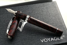Load image into Gallery viewer, The fountain pen with silver trims leaning on the cap.