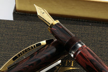 Load image into Gallery viewer, Close up to the fountain pen nib with gold vermeil trims leaning on the cap.