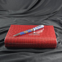 Load image into Gallery viewer, Angled view of the ballpoint pen on top of the red alligator embossed presentation box.