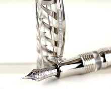Load image into Gallery viewer, Close up to the fountain pen's nib with the cap set behind it.