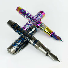 Load image into Gallery viewer, The blue and rainbow fountain pen Set arranged with their caps set underneath the barrels on a white background.