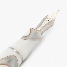 Load image into Gallery viewer, Close up to the Visconti Woodstock White Dove Fountain Pen nib. It is engraved with a set of decorations, 134K, M, and the word VISCONTI.