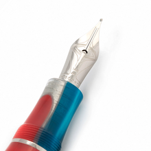 Load image into Gallery viewer, Close up to the Visconti Woodstock Lava Lamp Fountain Pen nib. It is engraved with a set of decorations, 134K, M, and the word VISCONTI.