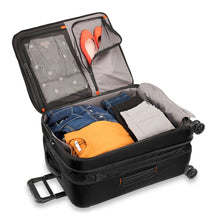Load image into Gallery viewer, Briggs & Riley ZDX Medium Expandable Spinner - Black
Image of spacious interior main compartment. Shown in expanded position and packed with clothing to illustrate generous capacity.  Image also showing two zippered compartments in lid panel for extra organization.
	Height	Width	Depth   Weight
US	26"	         18"	        12"	       10.4 lbs.
EU	66 cm	45.7 cm	30.5 cm	4.7 kg