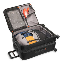 Load image into Gallery viewer, Briggs & Riley ZDX Medium Expandable Spinner - Black
Image of spacious interior main compartment shown with cinch down garment panels engaged to keep contents from shifting in transit. 
	Height	Width	Depth   Weight
US	26"	         18"	        12"	       10.4 lbs.
EU	66 cm	45.7 cm	30.5 cm	4.7 kg