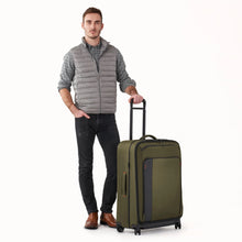 Load image into Gallery viewer, Briggs & Riley ZDX Large Expandable Spinner Luggage - Hunter Green
Front Angled Image of ZDX Large Expandable Spinner Luggage with male model.
	Height	Width	Depth	Weight
US	 29"	         20"	         12"	        11.4 lbs.
EU	73.7 cm	 50.8 cm	 30.5 cm	5.2 kg
