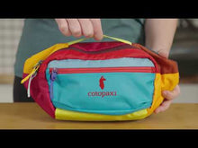 Load and play video in Gallery viewer, Review of the Kapai hip pack featuring the comfortable adjustable straps, paded compartments, zipper accessory pockets with key clips, and durable lightweight nylon fabric. Each one is made in one-of-a-kind colors.