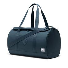 Load image into Gallery viewer, Angled front view of the orion blue duffle bag with the grab handles extended.
