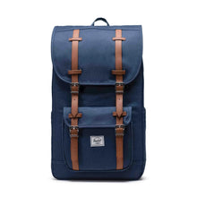 Load image into Gallery viewer, Front panel view of the navy blue backpack with tan faux leather straps and white logo tag.

