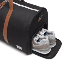 Load image into Gallery viewer, Close up to the side panel's shoe compartment with a pair of sneakers inside.
