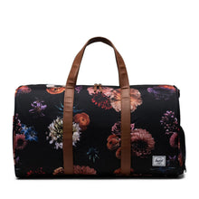 Load image into Gallery viewer, Front panel view of the black duffle bag with floral print.
