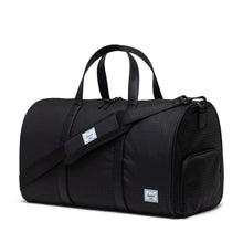 Load image into Gallery viewer, Black Houndstooth emboss duffle bag with a matching adjustable strap laid across the front.

