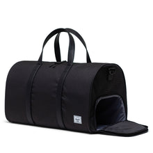 Load image into Gallery viewer, Angled view of the black duffle bag with houndstooth pattern. The side panel shoe compartment is unzipped.
