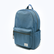 Load image into Gallery viewer, Angled front view of the steel blue backpack with Herschel logo tag on a white background.
