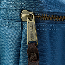 Load image into Gallery viewer, Close up to the front panel zipper with the word HERSCHEL engraved.
