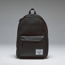 Load image into Gallery viewer, Front panel view of the Black Backpack with a white Herschel logo tag at the bottom. 
