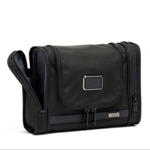 Load image into Gallery viewer, Front view of the hanging kit with the left pocket open. 
