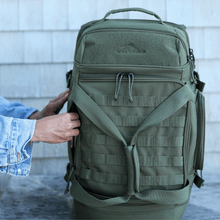 Load image into Gallery viewer, Short framed animation showing a pair of hands taking a cellphone, wallet, and sunglasses out from the moss green duffle bag pockets
