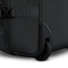 Load image into Gallery viewer, Angled close up to a wheel on the black duffel bag.
