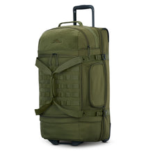 Load image into Gallery viewer, Angled front view of the moss green large duffle bag with black accents. The telescopic handle is pulled up. 
