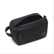 Load image into Gallery viewer, Angled view of the black tonal travel kit bag with the main compartment unzipped.
