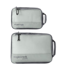Load image into Gallery viewer, Two light gray packing cubes with mesh tops and the Eagle Creek brand logo on the side.
