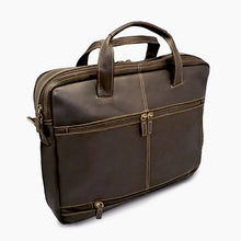 Load image into Gallery viewer, Angled front view of the brown leather brief with light tan stitching. It has a zipper-closing attachment strap to hold it onto a briefcase
