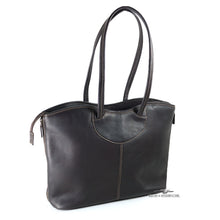 Load image into Gallery viewer, Angled back view of the black leather tote bag. The shoulder traps are pulled up. 
