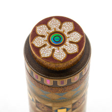 Load image into Gallery viewer, Bottom view of the pen. It has a design of a flower outlined in gold lacquer, and filled with white mother of pearl pieces. The center is a circle cut from abalone shell. 
