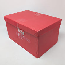 Load image into Gallery viewer, Angled view of the red cardboard box for the wooden watch chest. It has a tag, tape, and tear marks on the side panel. 
