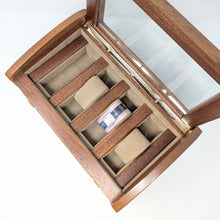 Load image into Gallery viewer, Top view of the wooden chest with the windowed lid opened. It has four slots for the watches and three pillows. 
