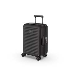 Load image into Gallery viewer, Angled front view of the hard shell suitcase with the telescopic handle partly extended. 
