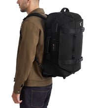 Load image into Gallery viewer, Alpha Bravo 2 Wheeled Duffel Backpack Carry-On - Backpack feature with model
