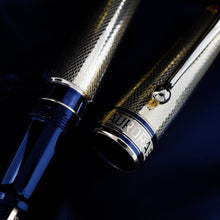 Load image into Gallery viewer, Close up to the grip section and the cap. The cap ring features an series of engraved lines, which spell out the word AURORA 
