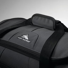 Load image into Gallery viewer, Detailed close up of the padded top handle of black wheeled drop bottom duffel.
