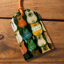 Load image into Gallery viewer, Colorful guitar-patterned luggage tag on a wooden surface
