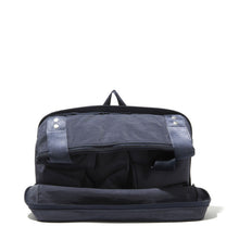 Load image into Gallery viewer, Semi-opened view of the folded navy bag.
