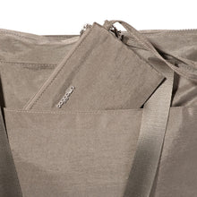 Load image into Gallery viewer, Close up to a compartment on the outside of the bag with the included anti-theft bag.
