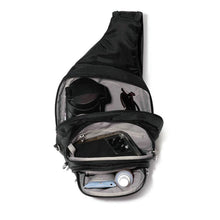 Load image into Gallery viewer, Top view of the bag with the compartments opened on a white background. An arrangement of accessories like a water bottle, sunglasses, a phone, a spray bottle and sun screen are arranged inside.
