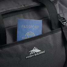 Load image into Gallery viewer, Close up to the front pocket of the black duffel backpack with a passport partly stored in the pocket. 

